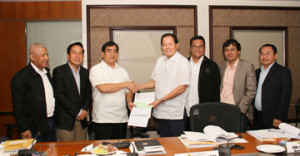 Public Works Undersecretary Romeo S. Momo (third from left) receives from PPA Board chairman Julianito G. Bucayan a check for P20 million to help finance the rehabilitation of Haiyan-ravaged areas. Witnessing the event are PPA general manager Juan C. Sta. Ana (second from left), Marina deputy administrator for planning Atty. Nicasio Conti (third from right) and other board members.