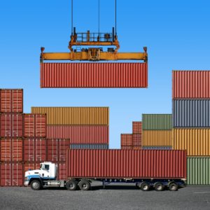 Stack of freight containers at the docks with Truck